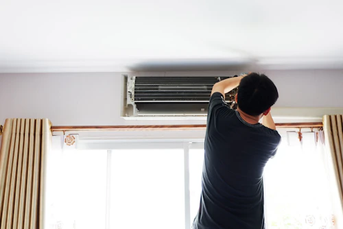 Person working on the AC in their condo