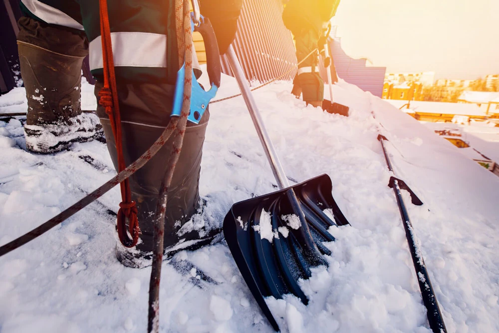 Workers shoveling in the snow How to Prepare Your Facility for Winter this Year